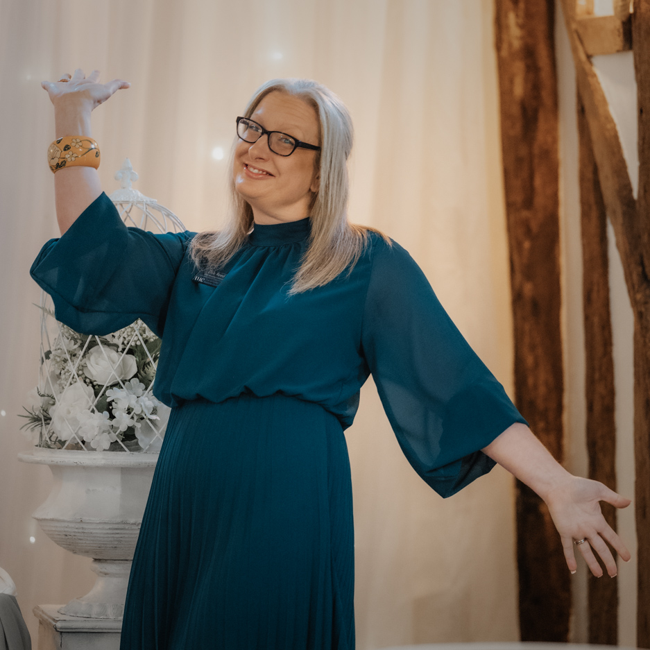 Deb Reed Celebrant Essex Colchester posing with arms out smiling.